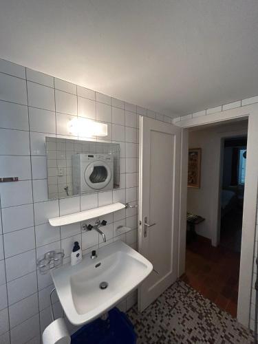 a bathroom with a sink and a microwave on the wall at Cache-Cache MOUNTAIN & QUIET chalet 10 pers in Veysonnaz