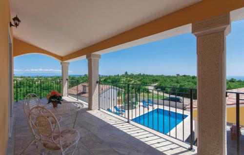 a balcony with a view of a swimming pool at Villa Santa Lucia - Istrian Oasis in Koromačno