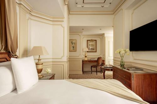 a hotel room with a bed and a television at Hotel Fenix Gran Meliá - The Leading Hotels of the World in Madrid