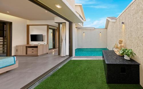 a living room with a couch and a television at Shivsagar Resort & Spa in Mahabaleshwar