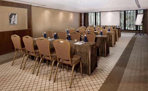 a conference room with a row of tables and chairs at Hotel Don Pepe Gran Meliá in Marbella