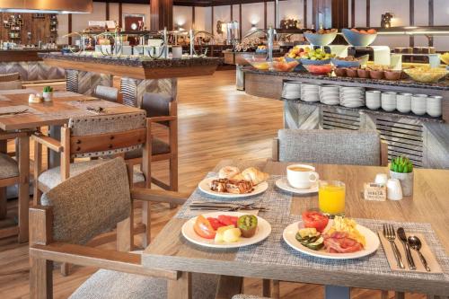 a breakfast table with plates of food on it at Melia Sierra Nevada in Sierra Nevada