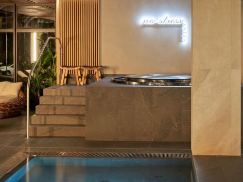a hotel lobby with a swimming pool and stairs at Mövenpick Resort & Spa Karpacz in Karpacz