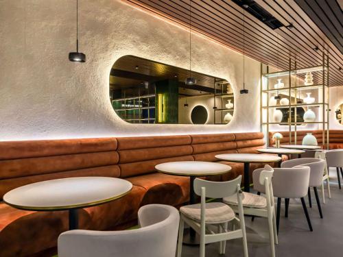 a row of tables and chairs in a restaurant at Mövenpick Resort & Spa Karpacz in Karpacz
