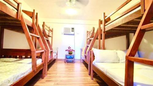 a room with four bunk beds in a hostel at Appleton Liitle Paradise Beach Resort & Restaurant Seaside Villa in Real