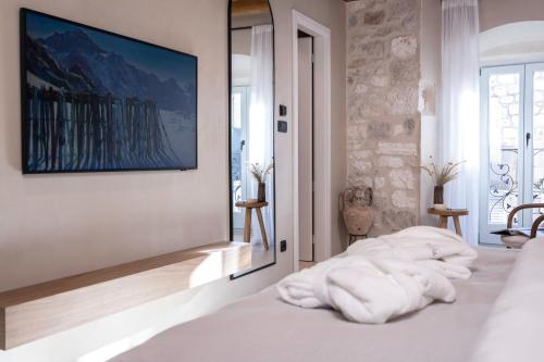 a bedroom with a bed with white towels on it at Forkira Luxury Hvar in Hvar