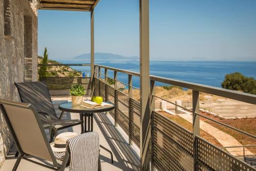 a balcony with a table and chairs and the ocean at Petradi Villa Skala I in Skala