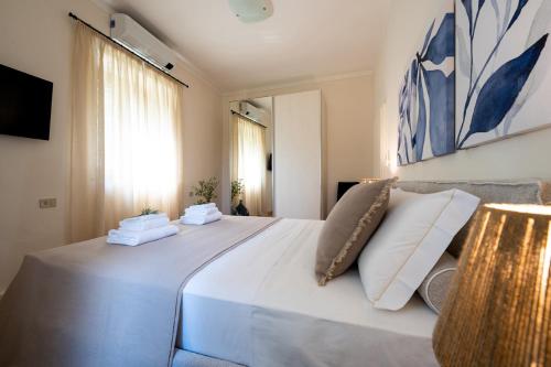 a bedroom with a large bed with two pillows on it at Luxury Villa with Private Pool and Lake View in Gargnano
