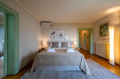 a bedroom with a large bed with two lamps at Luxury Villa with Private Pool and Lake View in Gargnano