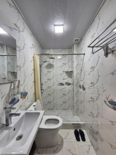 a bathroom with a toilet and a sink and a shower at YASMIN in Samarkand