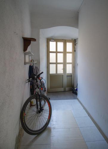 a bike is hanging on a wall in a hallway at B&B Apartments Coli Apatrman Viola Self check on the Ground floor in Bakar