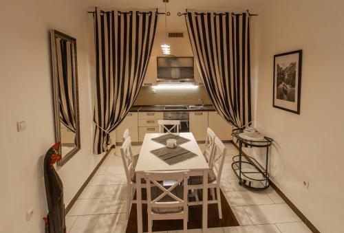 a dining room with a white table and chairs at B&B Apartments Coli Apatrman Viola Self check on the Ground floor in Bakar