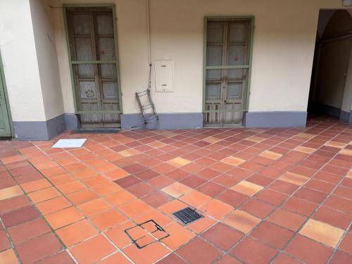 a chair on a tiled floor in front of a building at Bon Bon XX Settembre in Asti