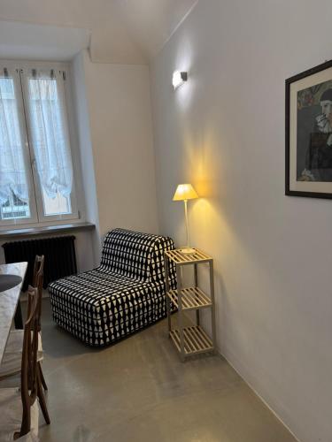a living room with a chair and a lamp at Bon Bon XX Settembre in Asti