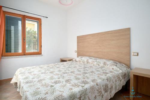 Ένα ή περισσότερα κρεβάτια σε δωμάτιο στο Residence fiorito spiaggia 300m by PortoOttioluAffitti