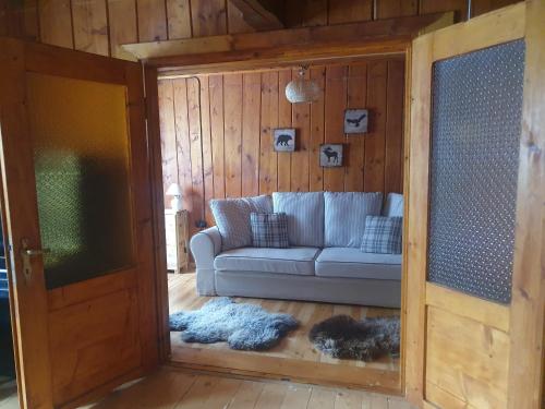 a living room with a couch and a sliding glass door at Łapszanka 29 in Łapszanka