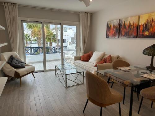 a living room with a couch and a table at Lanzarote Apartment Rental Harbour View in Tías
