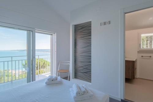 a white kitchen with a view of the ocean at Villa Elvise - YourPlace Abruzzo in Fossacesia