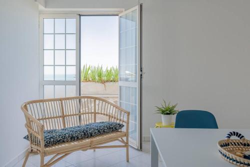 a room with a bench and a table and a window at Ferrante - YourPlace Abruzzo in Fossacesia
