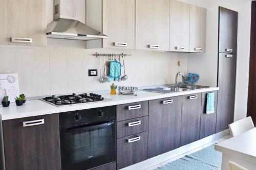 a kitchen with a stove and a sink at Gianna's House - YourPlace Abruzzo in Ortona