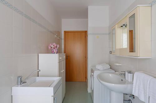 a white bathroom with a sink and a mirror at Borgata Marina 23 - YourPlace Abruzzo in Torino di Sangro