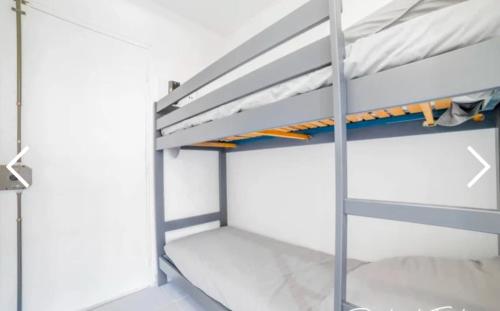 Ce lit superposé se trouve dans un dortoir aux murs blancs. dans l'établissement La petite Madrague, aux Lecques