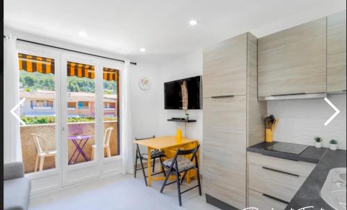 une cuisine avec une table et une salle à manger dans l'établissement La petite Madrague, aux Lecques