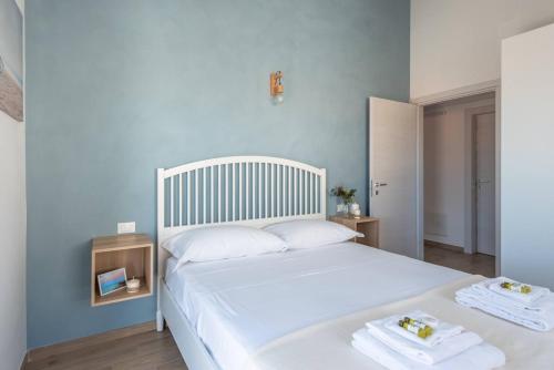 a bedroom with a white bed with towels on it at Blu Mare - YourPlace Abruzzo in Marina San Vito