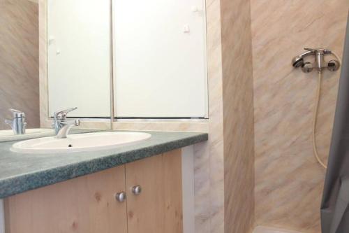 a bathroom with a sink and a mirror and a shower at Appt Studio LA ROCHELLE - LR030-A119Z in La Rochelle