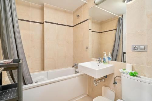 a bathroom with a sink and a bath tub at Penthouse by the beach in Torrox Costa