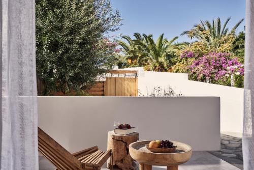 a patio with a table and a bowl of fruit at Dionysos Seaside Resort Ios in Mylopotas