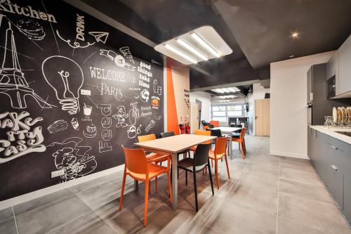 a dining room with a chalkboard wall with a table and chairs at 04 Studio Charenton Fitness Cinema in Charenton-le-Pont