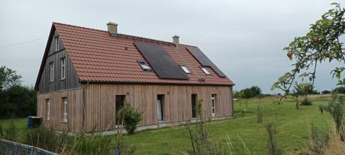 an old barn with a solar roof on a field at Fürstenau 29 in Fürstenau