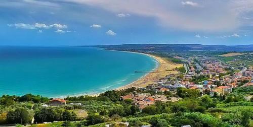 a view of a beach with a town and the ocean at Residence Near The Sea - Abruzzo in Martinsicuro