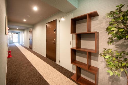 a hallway with wooden shelves on the wall at Hotel Neiraku in Nara
