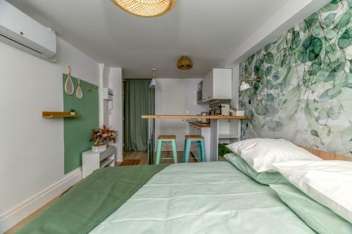 a bedroom with a bed and a kitchen at Le Jardin Secret - Centre ville - WIFI - by CLÉ HÔTES in Saint-Vallier