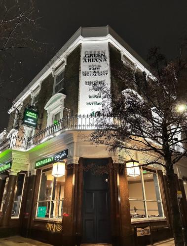 a building with a sign on the side of it at Green Ariana Hotel - near Wembley and central London in London