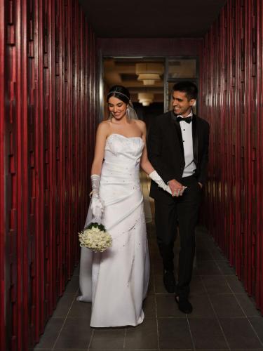 a bride and groom walking down a corridor at Taj Guras Kutir Resort & Spa, Gangtok in Gangtok