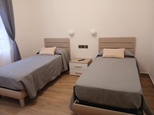 two beds in a small room with twoermottermott at Mountain View Hotel in La Digue