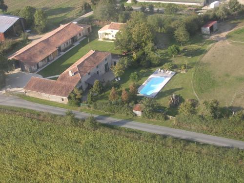 an aerial view of a house with a swimming pool at Le Vieux Logis de la Galocherie in Sainte-Florence