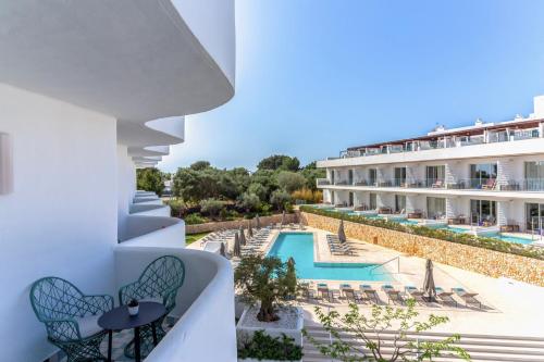 a view of the pool from the balcony of a hotel at Inturotel Cala Esmeralda Beach Hotel & Spa - Adults Only in Cala d´Or