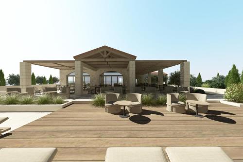 a wooden deck with chairs and a gazebo at The Yard Corfu Boutique Hotel and Spa in Corfu Town