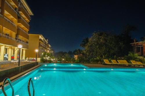 a swimming pool in a hotel at night at Alaya Stays 1 BHK with Balcony & Pool - Veera Marina in Goa