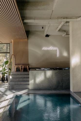 a swimming pool in a room with stairs and a pool at Mövenpick Resort & Spa Karpacz in Karpacz