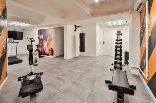 a gym with several exercise equipment in a room at 10 Studio Charenton Chambre Fitness Cinema in Charenton-le-Pont