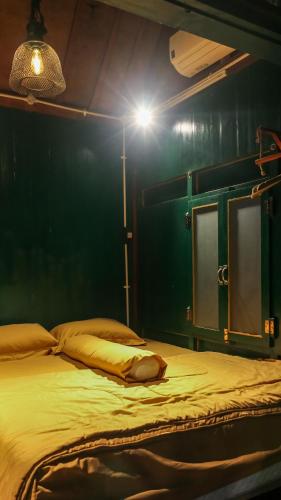 a bedroom with a bed with a light on it at Cokro Hinggil - Traditional View in Sleman