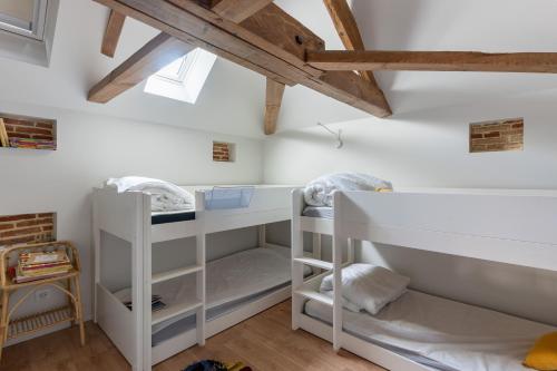 a room with two bunk beds in a attic at Demeure d'exception vue mer in Andernos-les-Bains