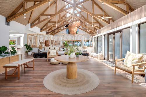 a large lobby with a table and chairs at Indian Ocean Lodge in Grand'Anse Praslin