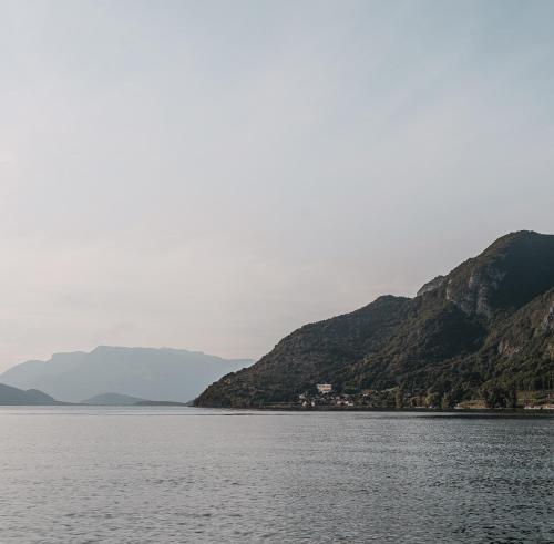 a large body of water with mountains in the background at Grand Hôtel Du Parc - Teritoria in Aix-les-Bains