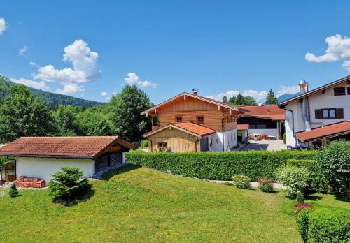 a view of a yard with houses and trees at Ferienwohnung Sonnenwinkl in Reit im Winkl